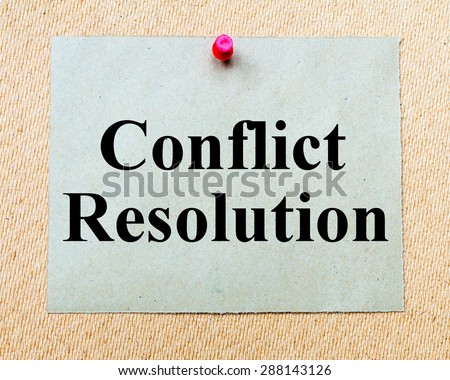 Conflict Resolution written on paper note pinned with red thumbtack on wooden board. Business conceptual Image