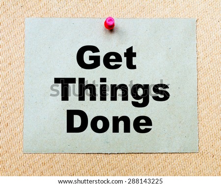 Get Things Done written on paper note pinned with red thumbtack on wooden board. Business conceptual Image
