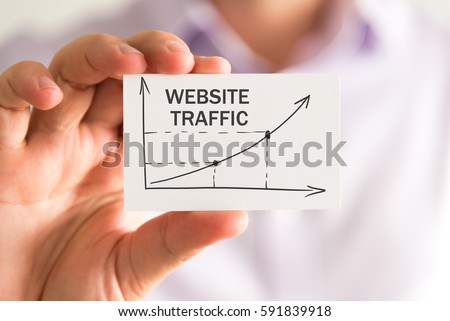 A man holding a paper that demonstrates website traffic