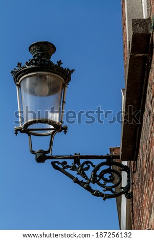 In Bruges you find this antique street lamps hanging longest wall
