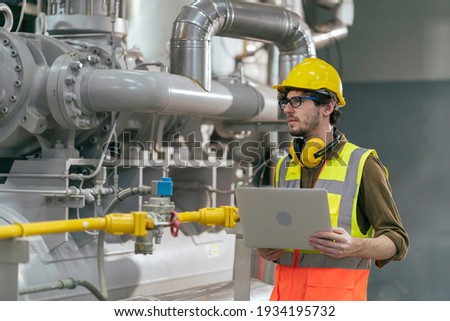 Portrait of HVAC engineer working in boiler room, Engineer working in gas boiler room for steam production of factory industrial manufactured, working in the boiler room, maintenance concept