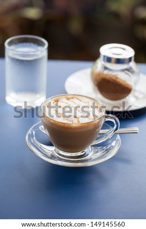 A flat white coffee with line pattern and short depth of field.