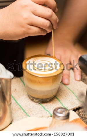 close up making art of coffee with bamboo stick