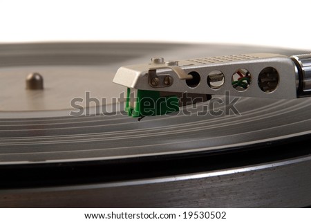 Turntable arm and cartridge  on black vinyl disk