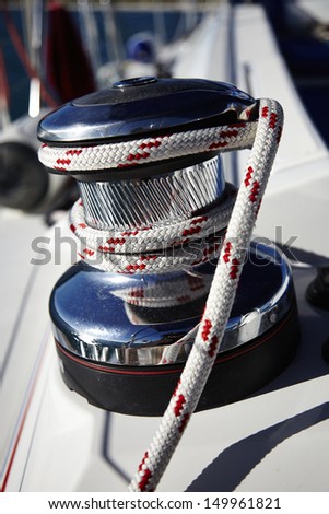 red rope tied around cleat on a boat