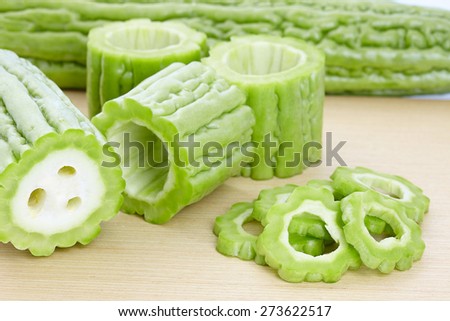 Bitter gourd slices on wooden in white background