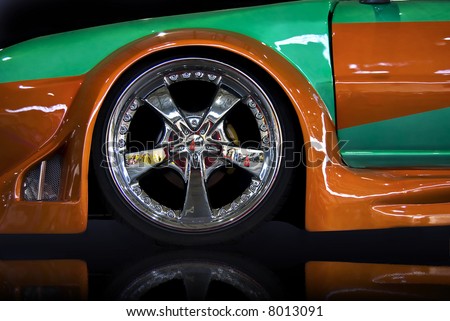 orange and green tuning car, isolated over black mirror