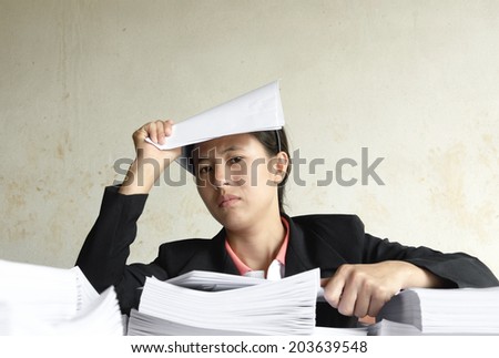 businesswoman serious with pile of paper
