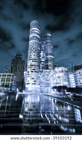 Modern european skyscraper at night, wide angle perspective, blue tones