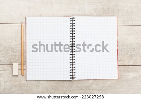 White open notebook on white wood background.