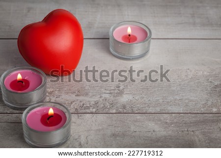 burning candles with red heart