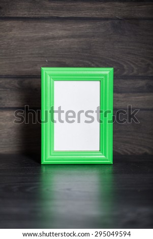 Empty photo frame on wooden background