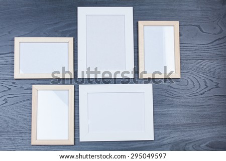 Empty photo frame on wooden background
