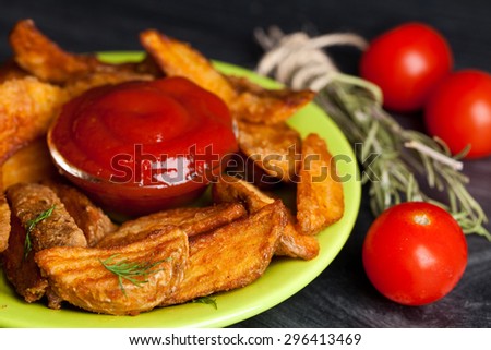 French fries potato on wooden old background. Fast food. Closeup.