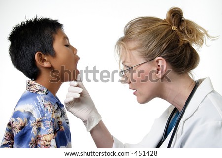 Child having a routine physical exam by doctor