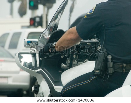 Motorcycle cop showing communication tools on belt