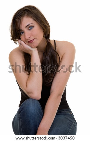 Portrait of an attractive brunette in pigtails in casual attire smiling sitting on white background