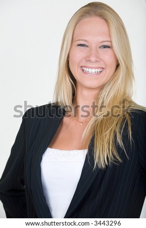 Attractive blond woman dressed in professional business suit with laughing expression