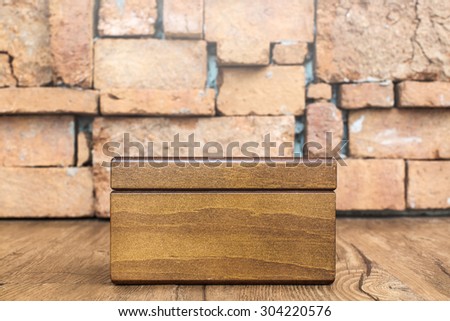 blank wooden box with stone wall  backgroubd
