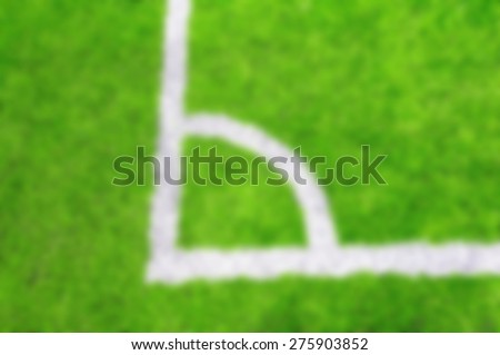 Photo of a green synthetic grass sports field with white line shot - Blurred picture style