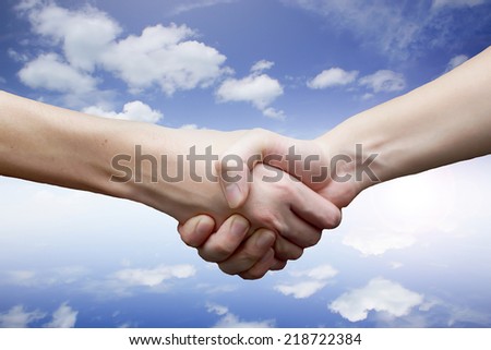 hand on sky background.The partnership concept.