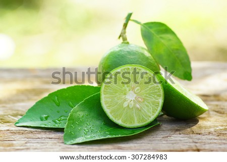 lemon with green leafs on wood background