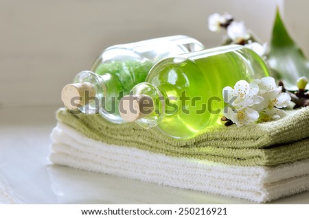 Refreshing spring spa set with scented sea salt and essential oil for massage or aroma therapy decorated with apricot flowers