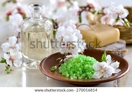 Spa set with green sea salt, handmade soap and massage oil decorated with spring blooming branches