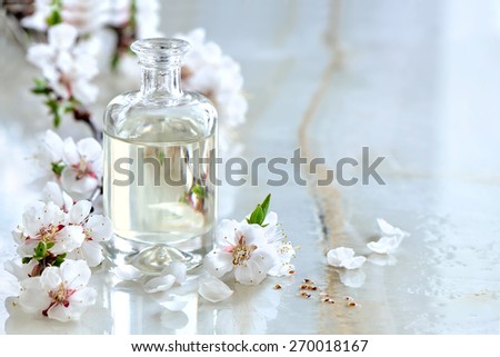 Spa massage oil decorated with spring blooming branches, special formula of essential oils; exclusive and luxury product