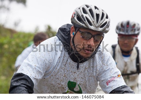 ZAMORA REGION, ECUADOR-JULY  13 2013:Rider Fernando Ortega Aguirre  in the rain and mud in the Andes Mountains on July 13, 2013. Governments in Ecuador are actively promoting fitness activities.