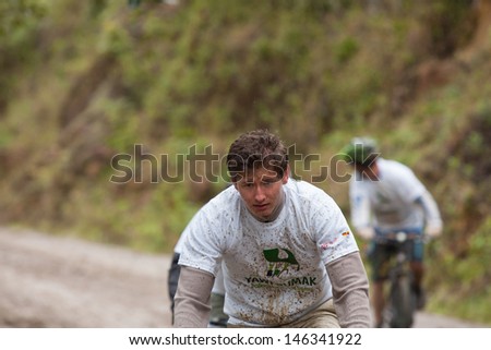 ZAMORA REGION, ECUADOR-JULY  13 2013:Rider Victor Gravot  in the rain and mud in the Andes Mountains on July 13, 2013. Governments in Ecuador are actively promoting fitness activities.