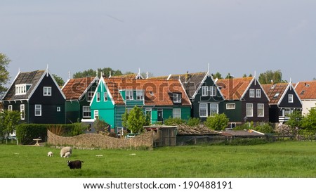 Historic Dutch fishermen village with green wooden houses called Marken