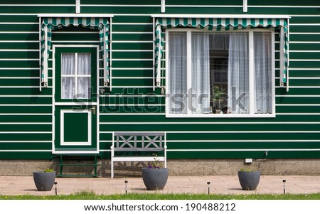 Historic Dutch fishermen village with green wooden houses called Marken