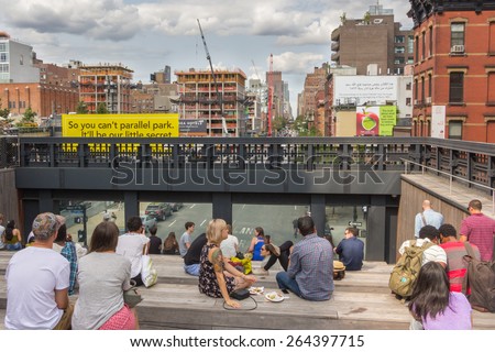 NEW YORK CITY - JULY 29,2014: People resting in High Line Park in New York. The High Line is a public park built on an old railway track elevated above the streets of Manhattan.