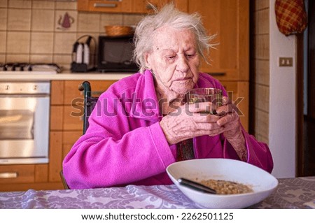 Similar – Foto Bild Einsame ältere Frau, die ihr Mittagessen im Altersheim verzehrt.