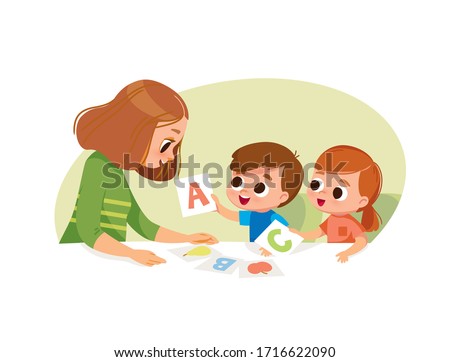 Mother with two kids. Early education. Learning alphabet with flashcards.
