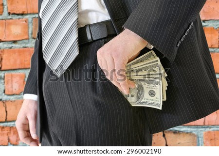 Man in a business suit put money in your pocket