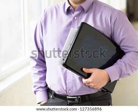 Businessman holding a laptop and working on it