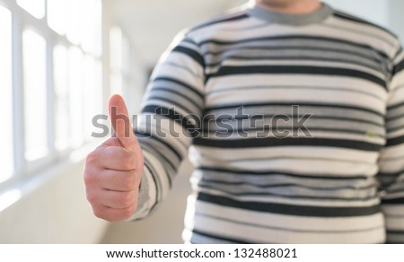 Businessman holding a thumb up, ok, super