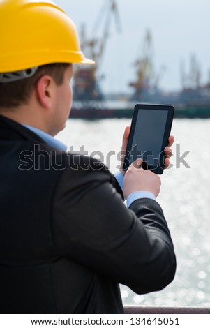 Port engineer is using the digital tablet