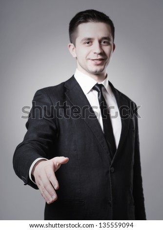 Handshake - Hand holding on gray background