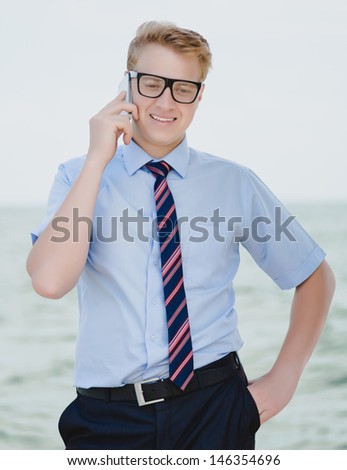 successful young businessman with phone