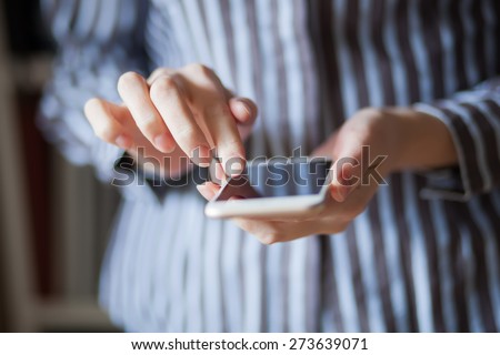 Young woman using a touchscreen smartphone.