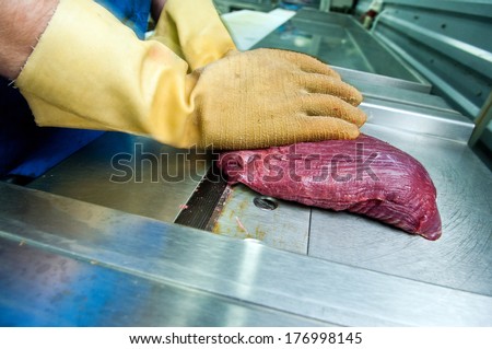 ostrich meat steak on the grinding machine