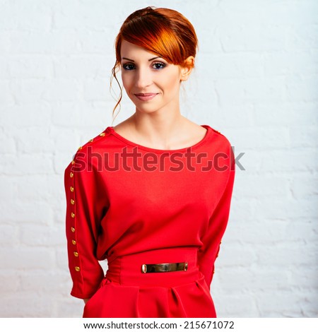 Beautiful young fashionable woman posing in red dress, smiling, looking at camera. Vogue Style. Photo with instagram style filters