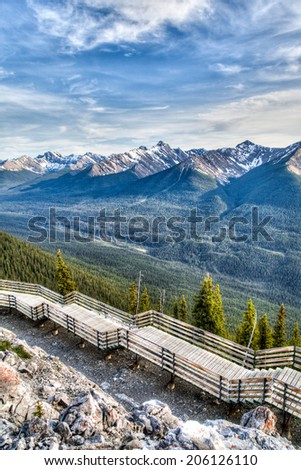 Interpretive walkway on the summit of Sulphur Mountain overlooking mountain ridges in Banff, Alberta, Canada.