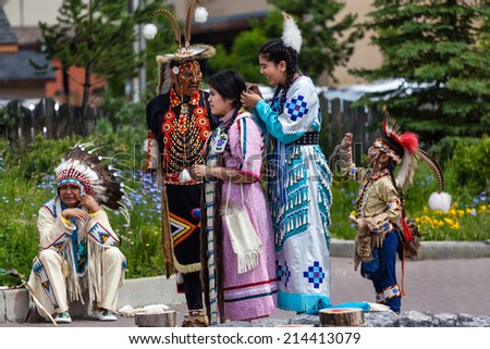 BANFF, CANADA - JUL 3: Young native Blackfoot Indian dancers put the finishing touches on their costumes for their performance during the Banff Summer Arts festival July 3, 2014.