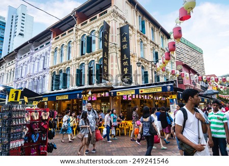 SINGAPORE - DECEMBER 15: Shoppers and diners visit Chinatown for bargain souvenirs and authentic local food Dec. 15, 2014. The old Victorian-style shophouses are a trademark of this popular area.