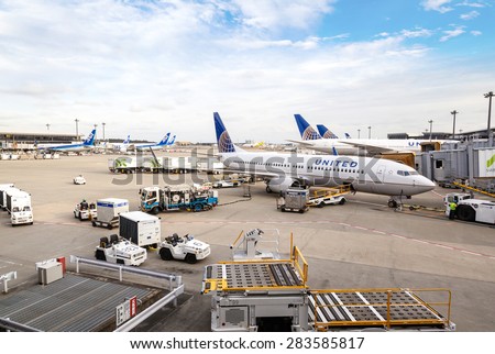 TOKYO - MARCH 6: A fleet of United Airlines planes being serviced on the tarmac of Narita Airport Mar. 6, 2015. After its merger with Continental in 2010, United has become the world\'s largest airline
