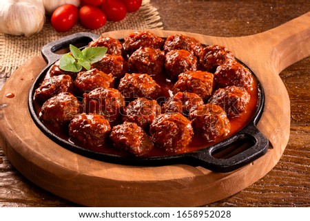 Traditional spicy meatballs in tomato sauce on wooden background. Selective focus Foto stock © 